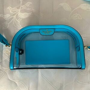 Kate Spade clear purse with sky blue trim and gold accents